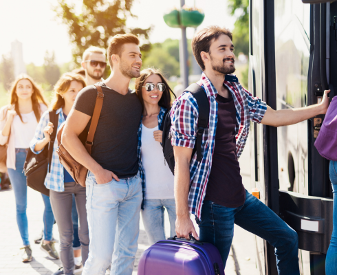 a group of people board a charter bus