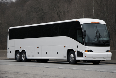 a large white charter bus parked